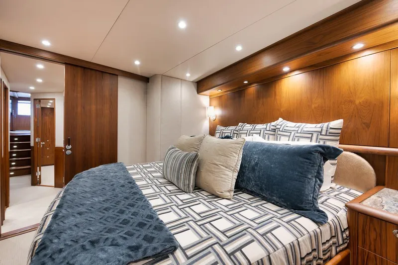 Artemis Yacht Photos Pics Luxurious bedroom interior of 2020 Merritt 77 Sportfish Convertible yacht with elegant bedding and wood accents.