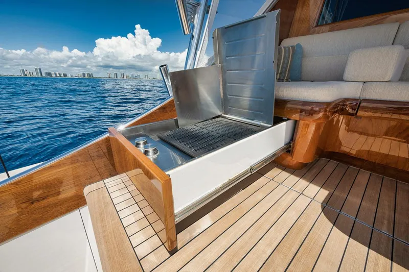 Artemis Yacht Photos Pics Luxury Merritt 77 Sportfish Convertible yacht with open grill, teak deck, ocean view.