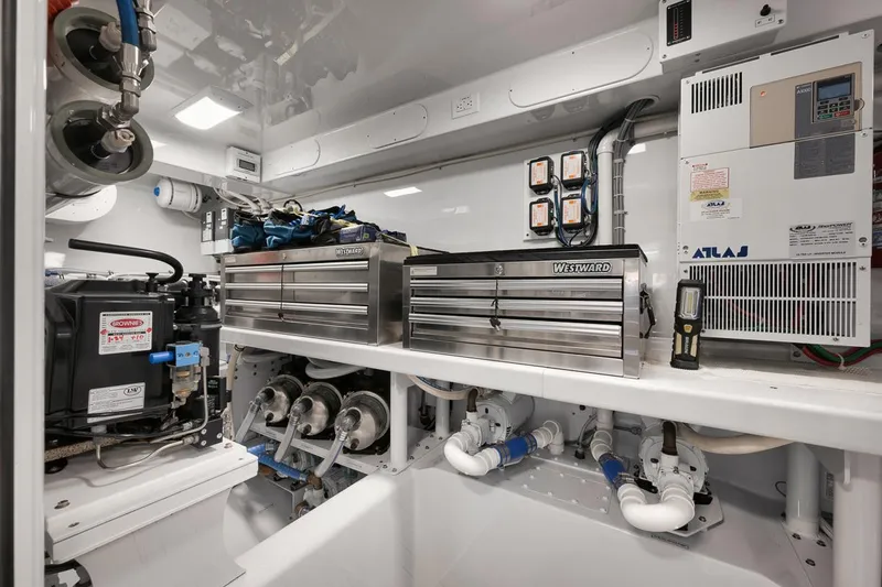 Artemis Yacht Photos Pics Engine room of 2020 Merritt 77 Sportfish Convertible with toolboxes and equipment.