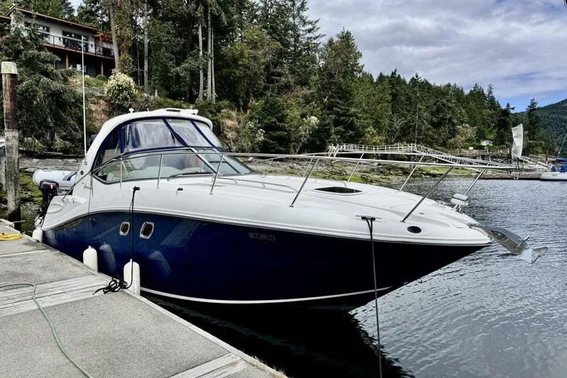  Yacht Photos Pics 2008 Sea Ray 330 Sundancer docked by a scenic forested shoreline.
