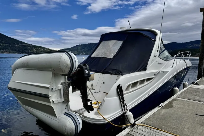  Yacht Photos Pics 2008 Sea Ray 330 Sundancer yacht docked by scenic lake with inflatable boat attached.