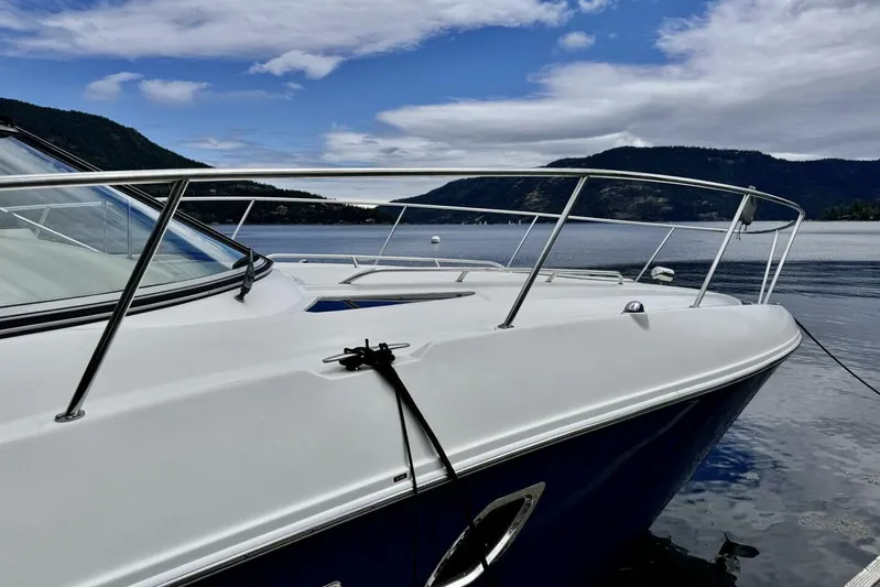  Yacht Photos Pics 2008 Sea Ray 330 Sundancer yacht on a serene lake with mountainous backdrop.