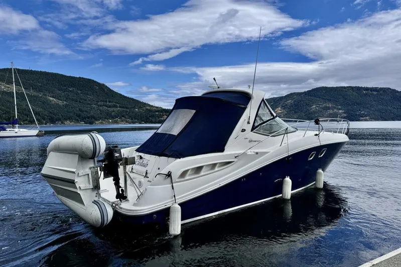  Yacht Photos Pics 2008 Sea Ray 330 Sundancer yacht on serene lake with mountainous backdrop.