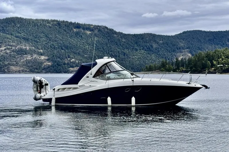  Yacht Photos Pics 2008 Sea Ray 330 Sundancer yacht on a serene lake with forested hills.