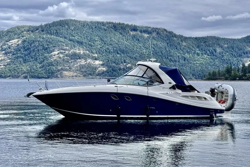  Yacht Photos Pics 2008 Sea Ray 330 Sundancer yacht on serene lake with forested hills in background.