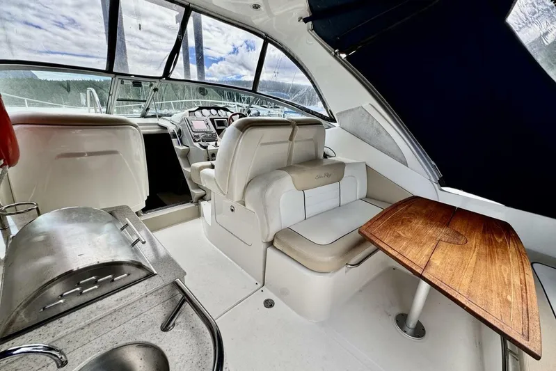  Yacht Photos Pics 2008 Sea Ray 330 Sundancer interior with helm, seating, and wooden table.