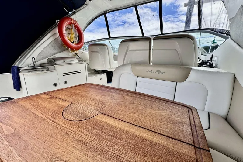  Yacht Photos Pics Interior of 2008 Sea Ray 330 Sundancer with wooden table and seating area.