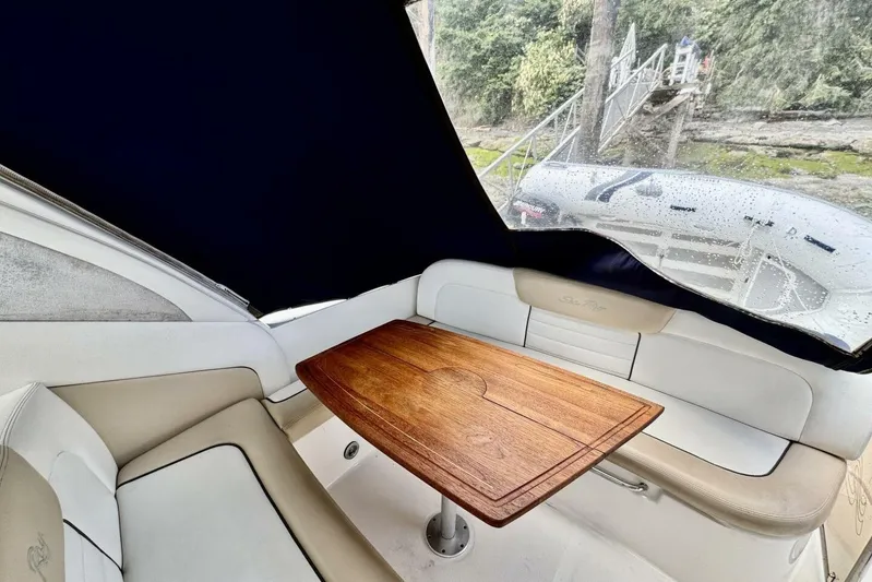 Yacht Photos Pics Interior of 2008 Sea Ray 330 Sundancer with wooden table and cushioned seating.