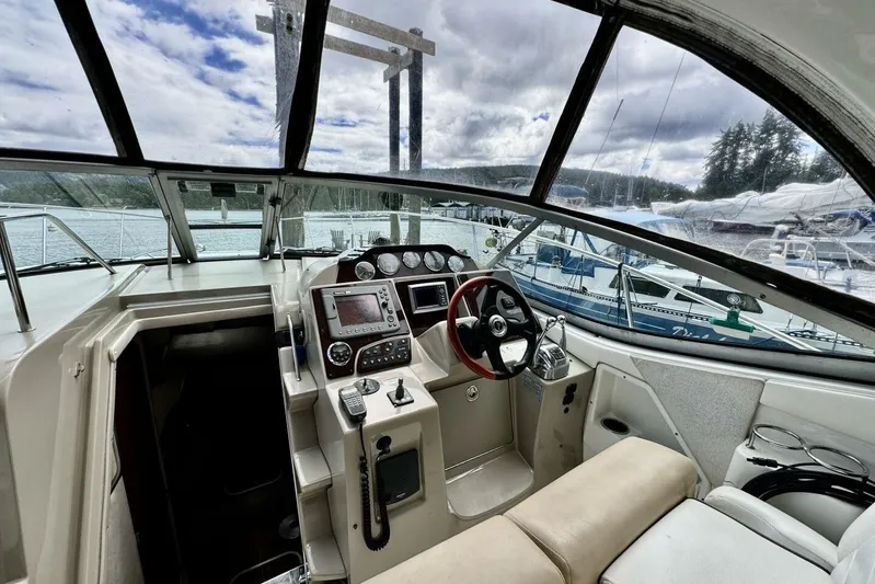  Yacht Photos Pics 2008 Sea Ray 330 Sundancer cockpit with steering wheel, navigation controls, and marina view.