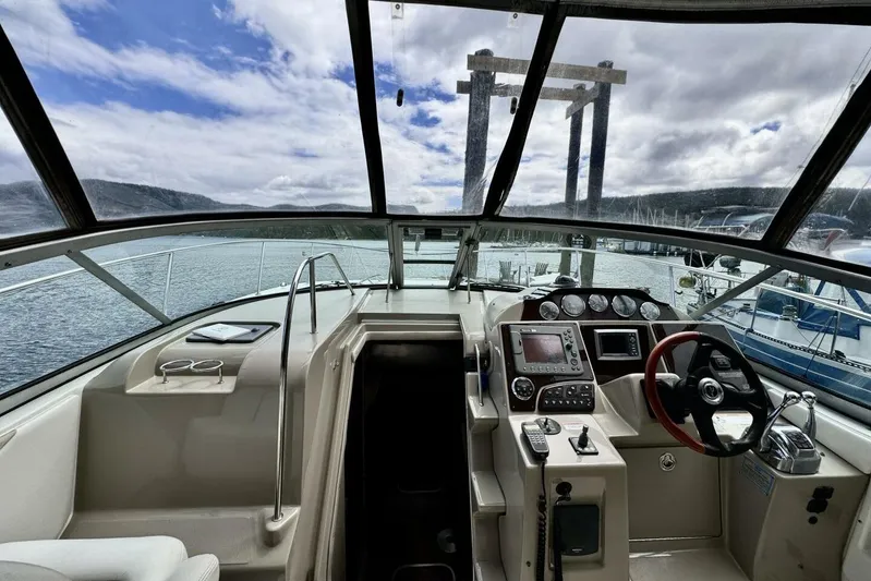  Yacht Photos Pics 2008 Sea Ray 330 Sundancer cockpit with steering wheel, dashboard, and marina view.