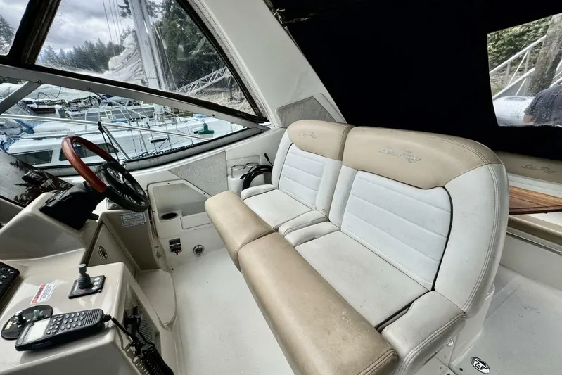  Yacht Photos Pics 2008 Sea Ray 330 Sundancer cockpit with beige and white seating, steering wheel, and control panel.