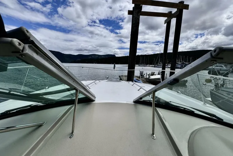  Yacht Photos Pics 2008 Sea Ray 330 Sundancer yacht docked, scenic marina view, cloudy sky.