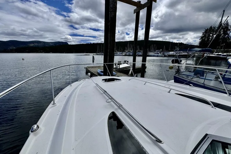  Yacht Photos Pics 2008 Sea Ray 330 Sundancer docked at a scenic marina with cloudy skies.