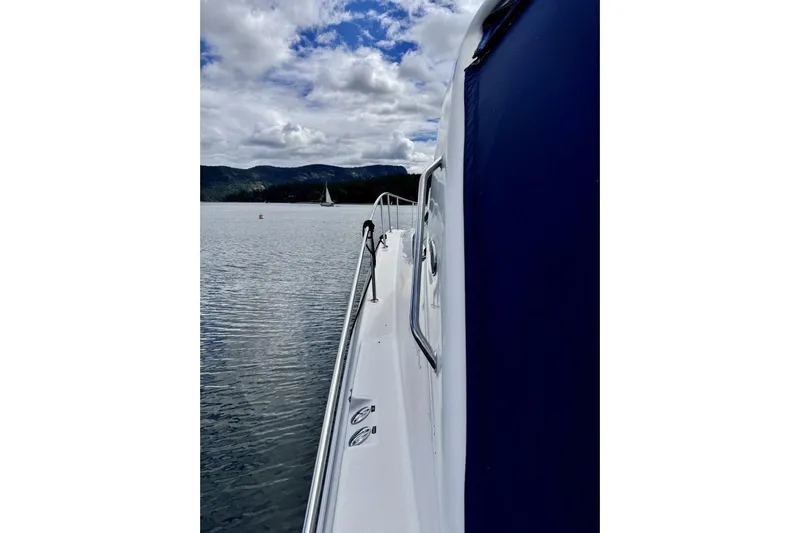  Yacht Photos Pics 2008 Sea Ray 330 Sundancer on calm water with scenic mountain backdrop.