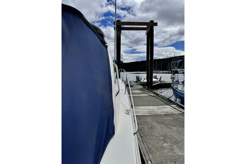  Yacht Photos Pics 2008 Sea Ray 330 Sundancer docked at marina under cloudy sky.