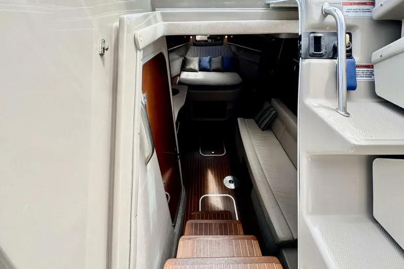  Yacht Photos Pics Interior view of 2008 Sea Ray 330 Sundancer cabin with seating and wooden flooring.