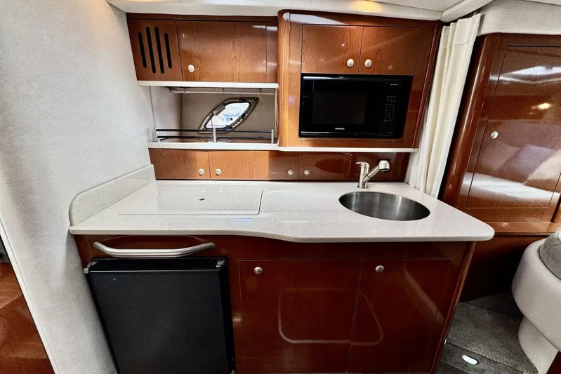  Yacht Photos Pics 2008 Sea Ray 330 Sundancer yacht interior kitchen with sink, microwave, and fridge.