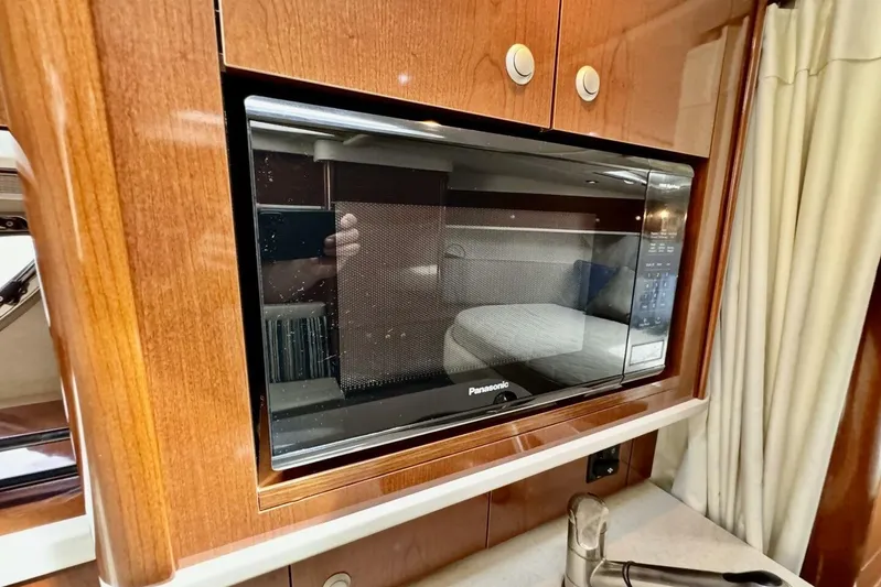  Yacht Photos Pics Microwave in 2008 Sea Ray 330 Sundancer yacht kitchen with wood cabinetry.