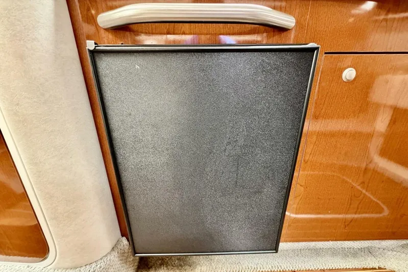  Yacht Photos Pics 2008 Sea Ray 330 Sundancer cabin interior with wooden cabinetry and a compact refrigerator.