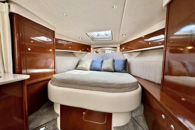  Yacht Photos Pics Luxurious interior of 2008 Sea Ray 330 Sundancer with cozy bed and elegant wood finish.
