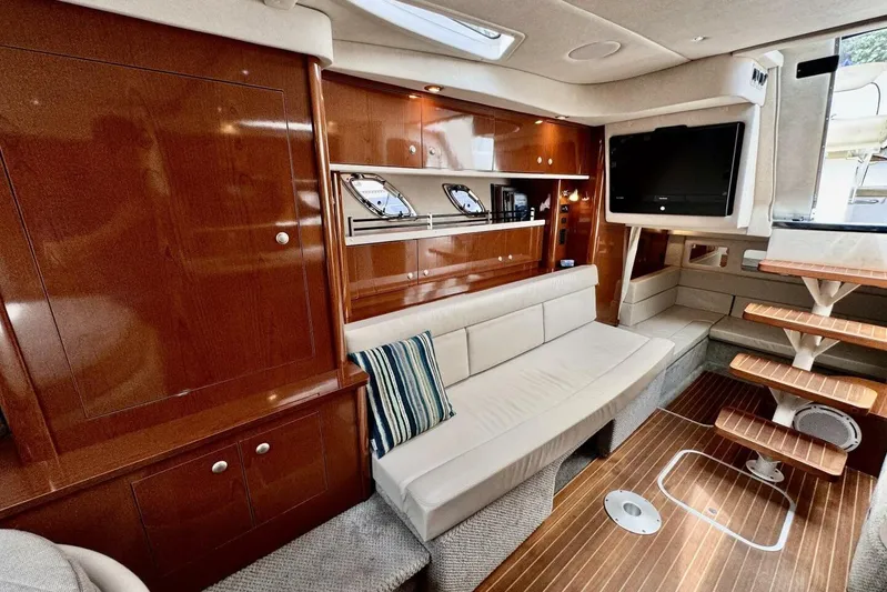  Yacht Photos Pics Luxurious interior of 2008 Sea Ray 330 Sundancer yacht with wood finishes and comfortable seating.