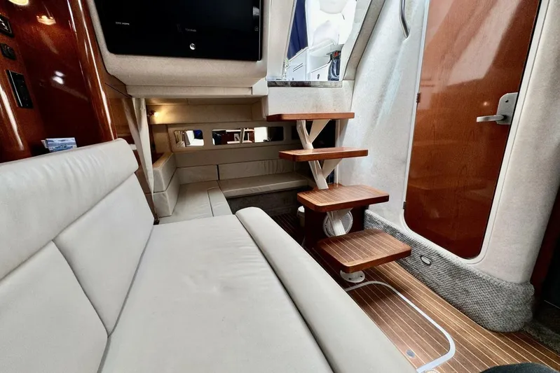  Yacht Photos Pics Interior of 2008 Sea Ray 330 Sundancer with wooden steps and beige seating.