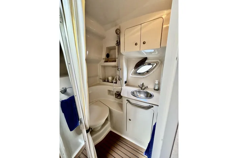  Yacht Photos Pics Compact bathroom in 2008 Sea Ray 330 Sundancer yacht with sink, toilet, and storage.