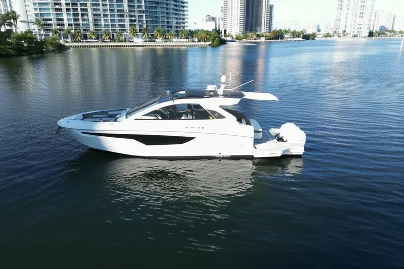  Yacht Photos Pics 2021 Cruisers Yachts 42 GLS OB on calm water, cityscape background.