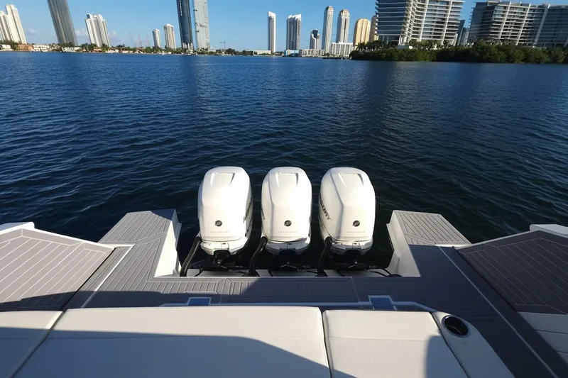  Yacht Photos Pics 2021 Cruisers Yachts 42 GLS OB with triple outboard engines on a calm waterfront.