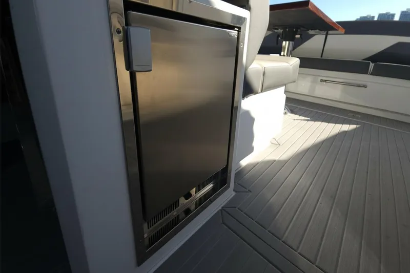  Yacht Photos Pics 2021 Cruisers Yachts 42 GLS OB deck with stainless steel fridge and seating area.