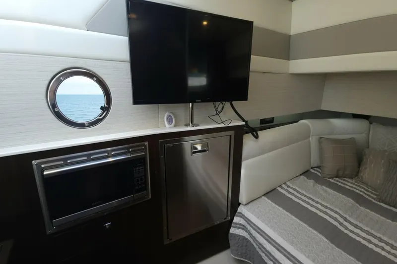  Yacht Photos Pics Interior of 2021 Cruisers Yachts 42 GLS OB with TV, microwave, and bed.