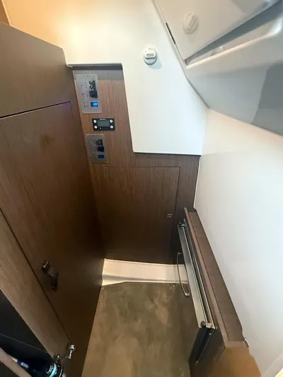 Rub A Dub Yacht Photos Pics 2023 Beneteau Antares 11 OB interior with control panels and wood finish.