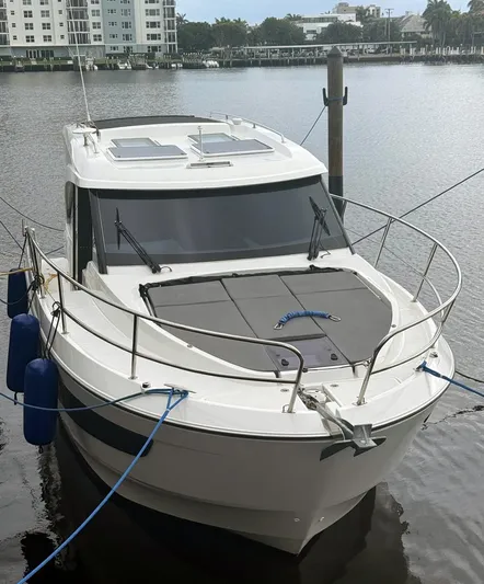Rub A Dub Yacht Photos Pics 2023 Beneteau Antares 11 OB boat docked in a marina, front view.