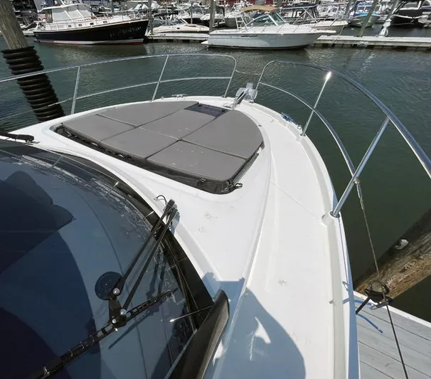 Rub A Dub Yacht Photos Pics 2023 Beneteau Antares 11 OB boat deck with sunpad, docked in marina.