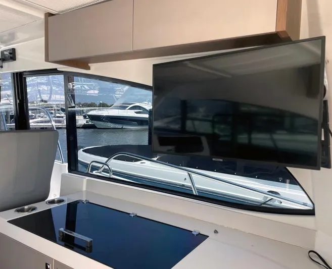 Rub A Dub Yacht Photos Pics Interior of 2023 Beneteau Antares 11 OB with TV and marina view.