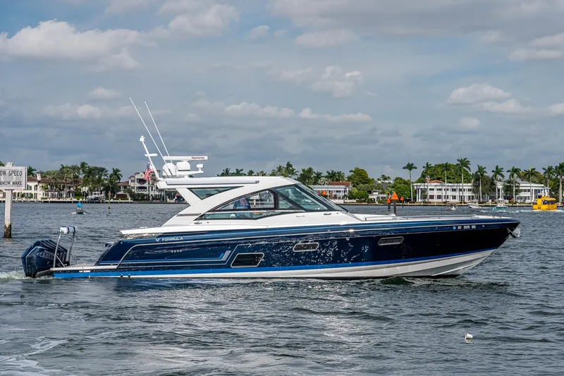  Yacht Photos Pics 2022 Formula 430 SSC luxury boat cruising on a scenic waterway.