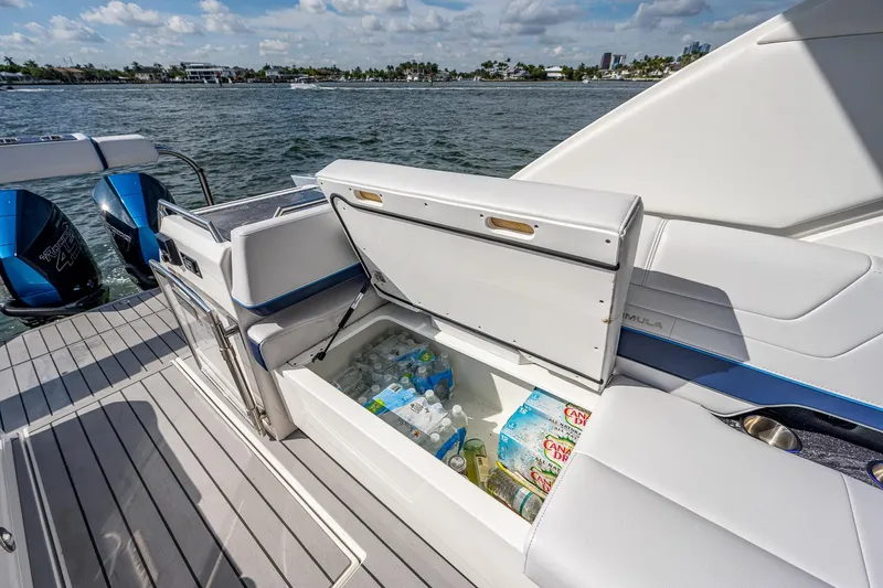  Yacht Photos Pics 2022 Formula 430 SSC boat with open storage compartment, stocked with drinks, on a sunny day.