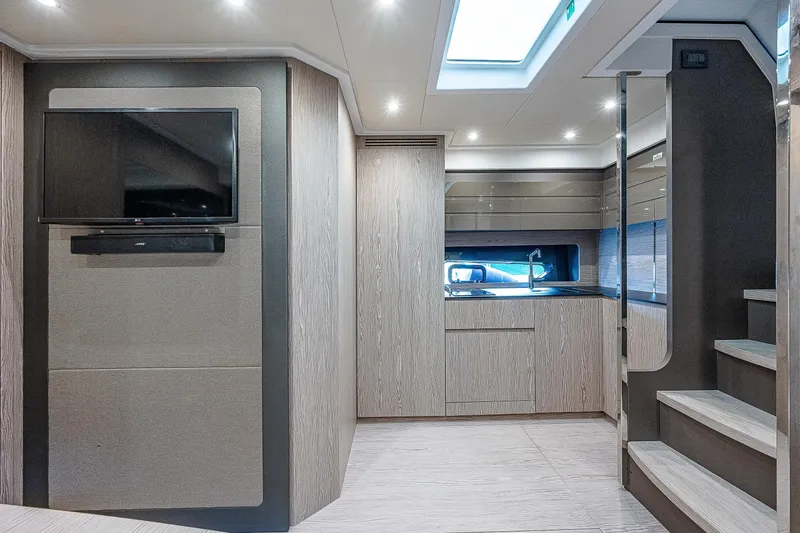  Yacht Photos Pics Luxurious interior of 2021 Azimut Atlantis 45 yacht with modern kitchen and TV.