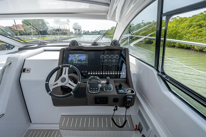  Yacht Photos Pics Helm of 2021 Azimut Atlantis 45 yacht with modern navigation controls and steering wheel.