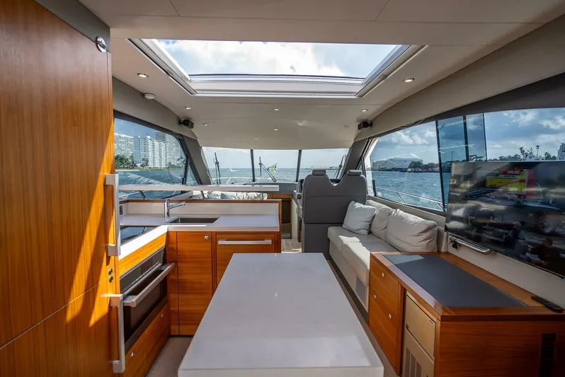Man Cave Yacht Photos Pics Luxurious interior of 2021 Maritimo X50 yacht with modern kitchen and seating area.