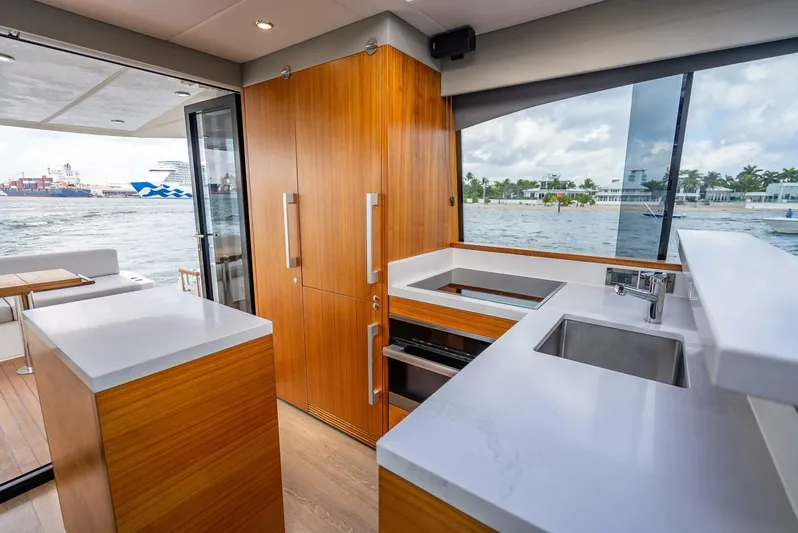 Man Cave Yacht Photos Pics Interior of 2021 Maritimo X50 yacht with modern kitchen and waterfront view.