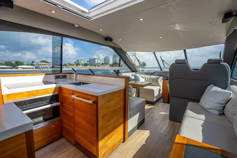 Man Cave Yacht Photos Pics Luxurious interior of 2021 Maritimo X50 yacht with modern kitchen and seating area.