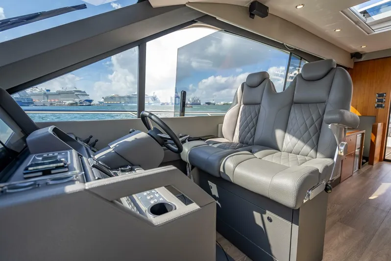 Man Cave Yacht Photos Pics 2021 Maritimo X50 yacht interior with luxurious seating and modern dashboard.