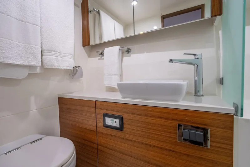Man Cave Yacht Photos Pics Modern bathroom in 2021 Maritimo X50 yacht with sleek sink and wooden cabinetry.