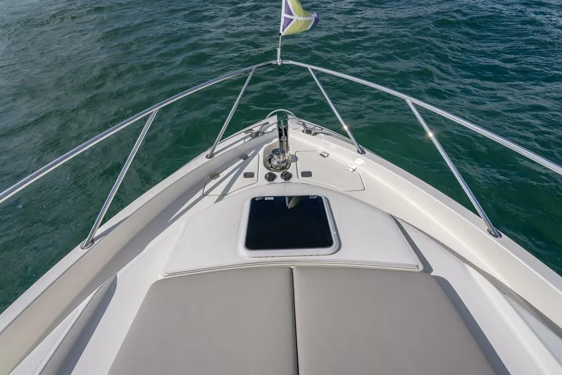 Man Cave Yacht Photos Pics 2021 Maritimo X50 yacht bow with sunpad and railing on open water.