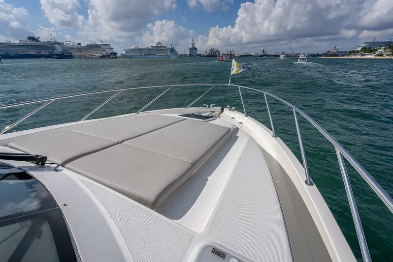 Man Cave Yacht Photos Pics 2021 Maritimo X50 yacht cruising in a busy harbor under a partly cloudy sky.