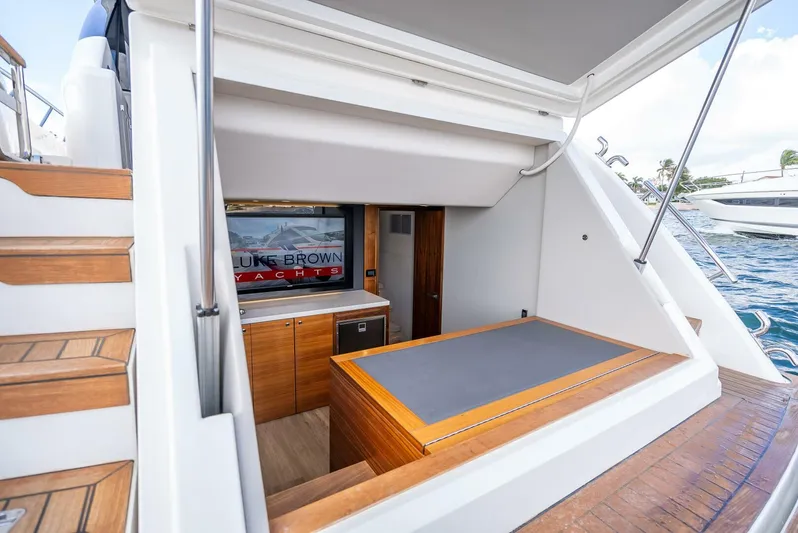 Man Cave Yacht Photos Pics 2021 Maritimo X50 yacht interior with wooden cabinetry and outdoor seating area.