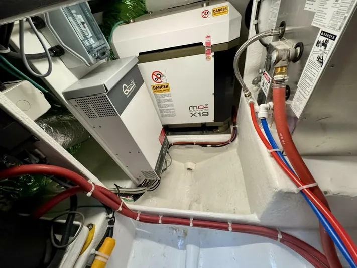 Man Cave Yacht Photos Pics Engine room of 2021 Maritimo X50 yacht with electrical equipment and wiring.