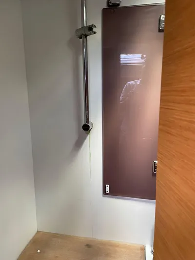 Hygge Yacht Photos Pics Shower area in 2017 Jeanneau Sun Odyssey 479 yacht, featuring modern fixtures and wooden accents.