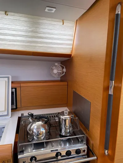 Hygge Yacht Photos Pics Galley kitchen in 2017 Jeanneau Sun Odyssey 479 sailboat with stove and kettle.